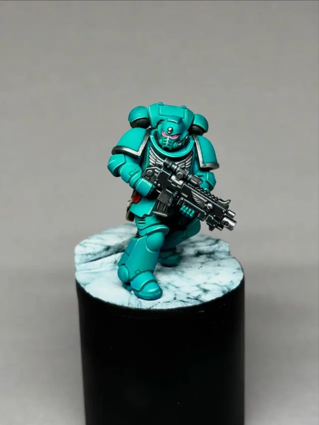 💎 Day 4: The Jade-Petrol Breakthrough

This one surprised me in the best way.

Not because it’s “perfect” — but because I never would’ve found this colorscheme if I wasn’t forcing myself to loosen up, airbrush more, and stop obsessing over every tiny mistake.

This mini took 3 hours, the longest so far… and honestly? It might be the prettiest of the whole experiment. The jade–petrol armor just clicked.

Process:

* Black primer
* Zenithal with Bold Titanium White
* Overcoat with Transparent Blue
* Another zenithal
* Final overcoat with Transparent Green
* Edge highlights with Sybarite Green and Gauss Blaster Green

Letting the colors breathe and build on each other made this scheme come alive.

Now I’m curious:

What would you name this chapter? 

And which First Founding chapter would you pick as their parent?